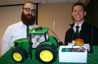 Mitchell Hinrichsen and John Pritchard, students at Iowa State University, pose with a prototype of their tractor rollover device.